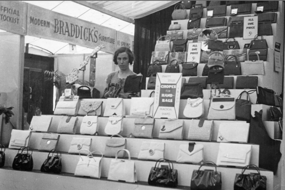 Black and white photograph of leather stall with ladies handbags