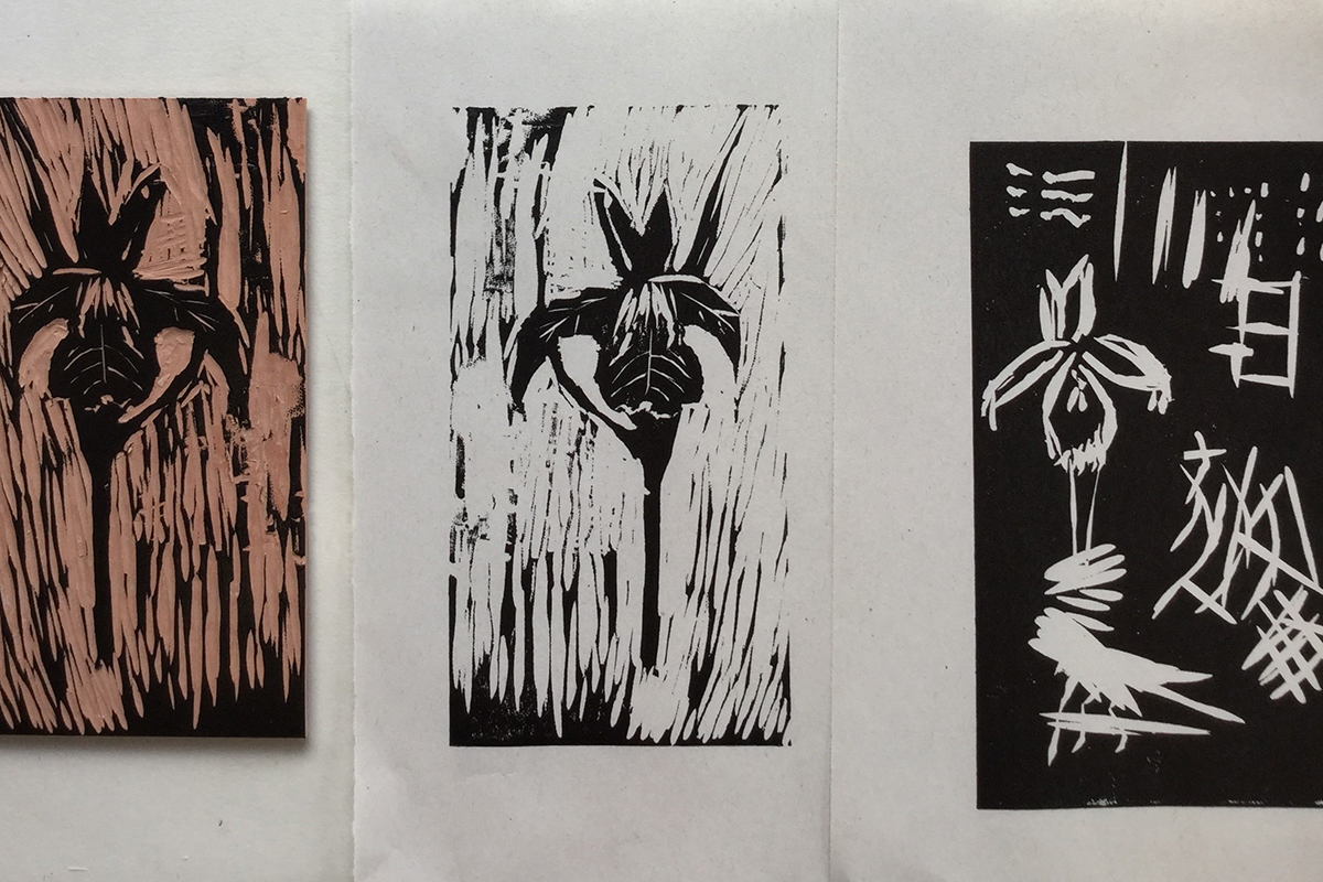 three linocut prints of flowers